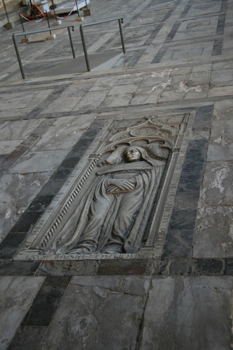 [Picture: bas-relief gravestone in the floor]