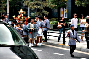 [picture: Child with staff leading the mikoshi]