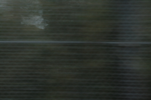 [Picture: blurred fence texture]